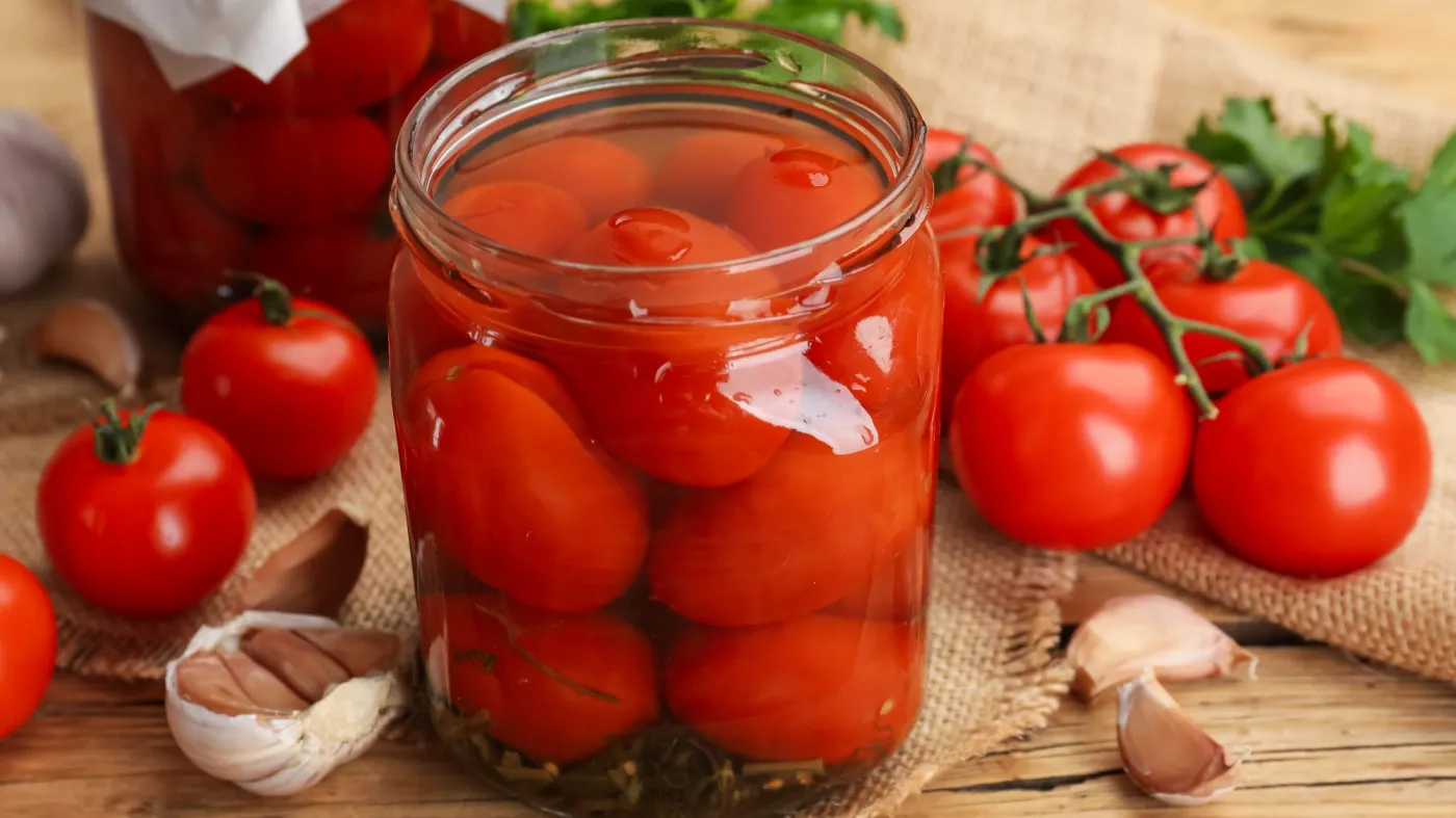 Tasty,Pickled,Tomatoes,In,Jars,,Fresh,Ones,And,Garlic,On