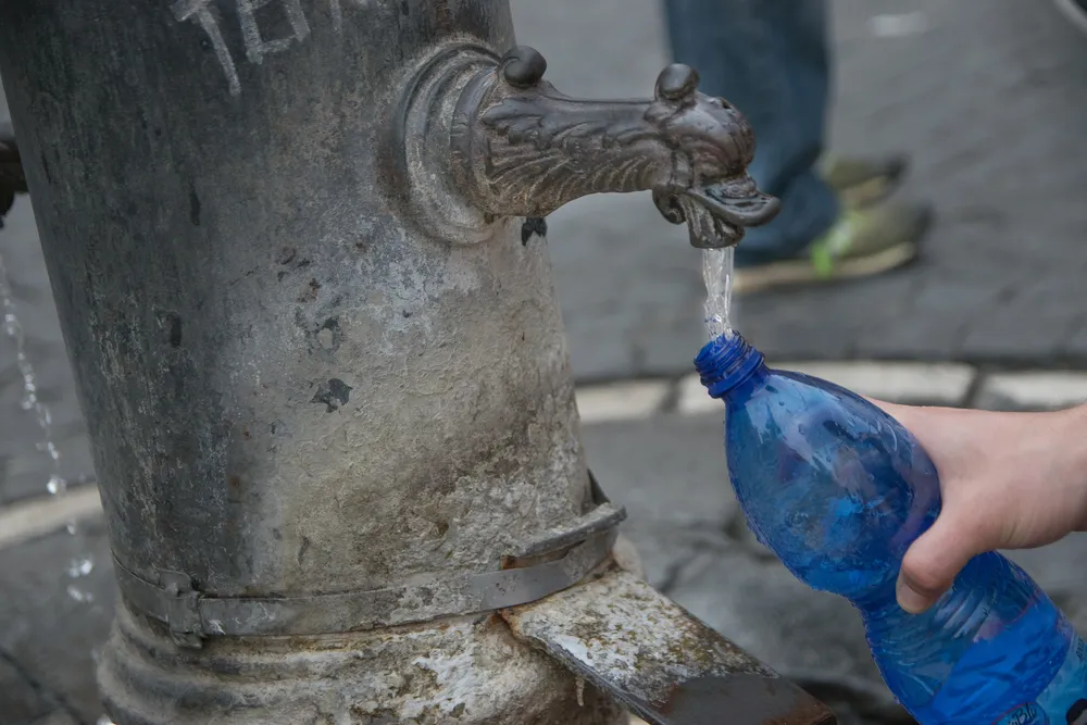 Filling,A,Bottle,With,Drinkable,Water,In,Public,Fountain,,Rome,