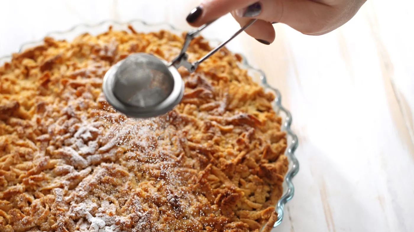 Tart,With,Apples.,Woman,Sprinkles,Cake,With,Powdered,Sugar.