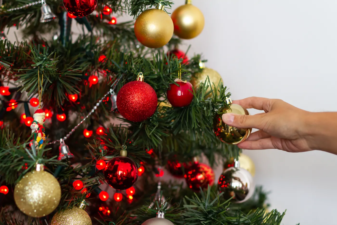 Woman's,Hand,Placing,Golden,Christmas,Ornament