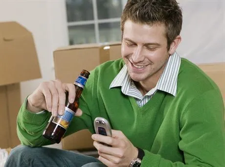 Man Taking a Break from Moving In to New Home --- Image by  Rick GomezCorbis