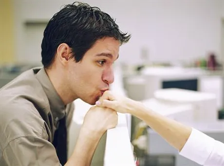 Man Kissing Co-Workers Hand --- Image by  Shannon FaganCORBIS