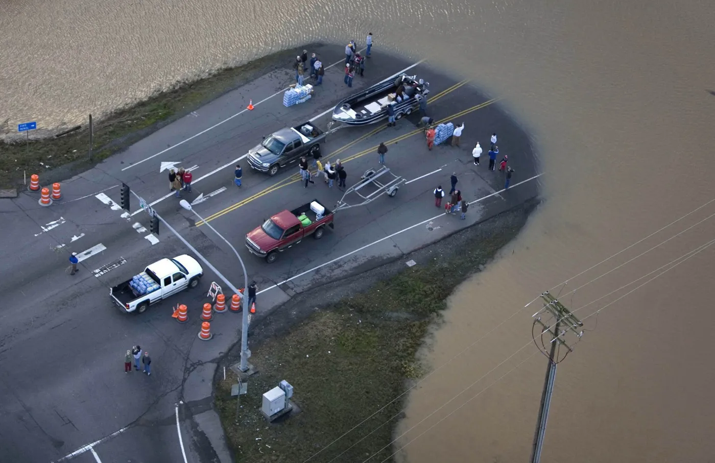 People are seen on a section of the flooded Interstate-5 in Chehalis, Wash. on Tuesday Dec. 4, 2007.  A storm that battered the Pacific Northwest for two days moved on Tuesday, leaving behind flooded homes, fallen trees and washed-out roads, including the region apos;s largest highway, which was covered with 10 feet of muddy water. AP PhotoThe Oregonian, Bruce Ely  NO MAGS. NO SALES  