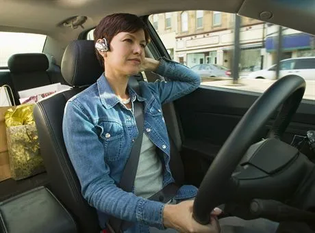 Businesswoman in Her Car --- Image by  Jim CraigmyleCorbis