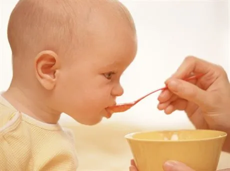 Feeding baby in yellow