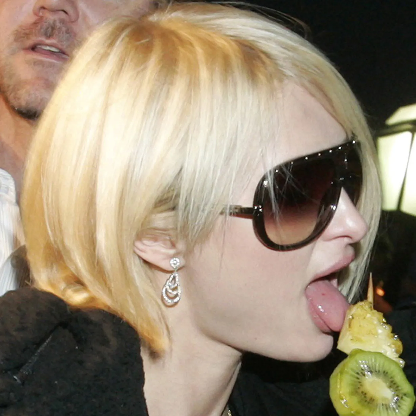 Paris Hilton eats a stick of fruit during her visit to the Bund on the bank of the Huangpu River in Shanghai November 22, 2007. Hilton is in Shanghai to attend 2007 MTV Awards on Friday. REUTERSAly Song CHINA