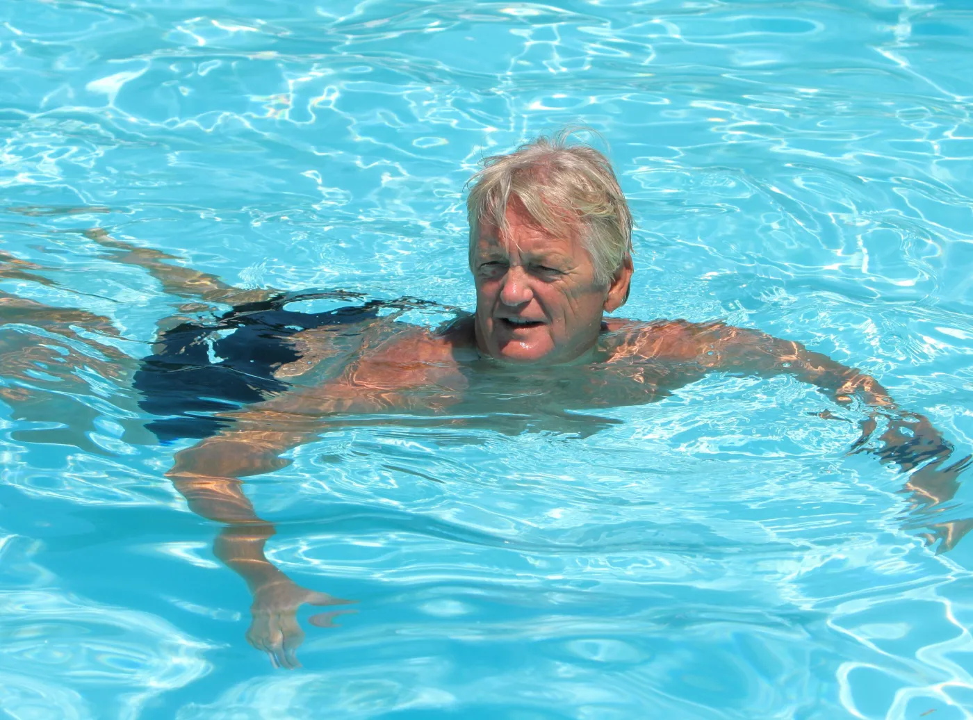 Mężczyzna pływa w basenie