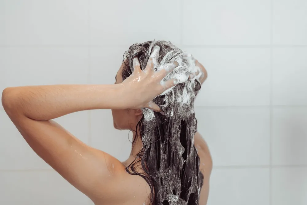Young,Woman,Washing,Hair,In,Shower.,Asian,Woman,Washing,Her