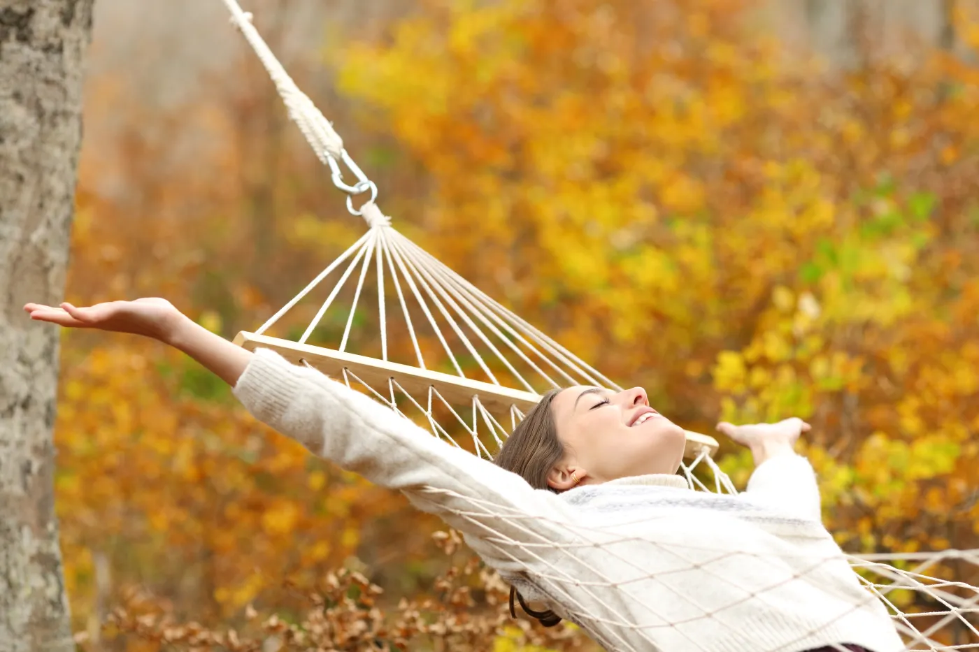 Happy,Woman,Celebrating,Autumn,Vacation,On,Hammock,Outstretching,Arms,In