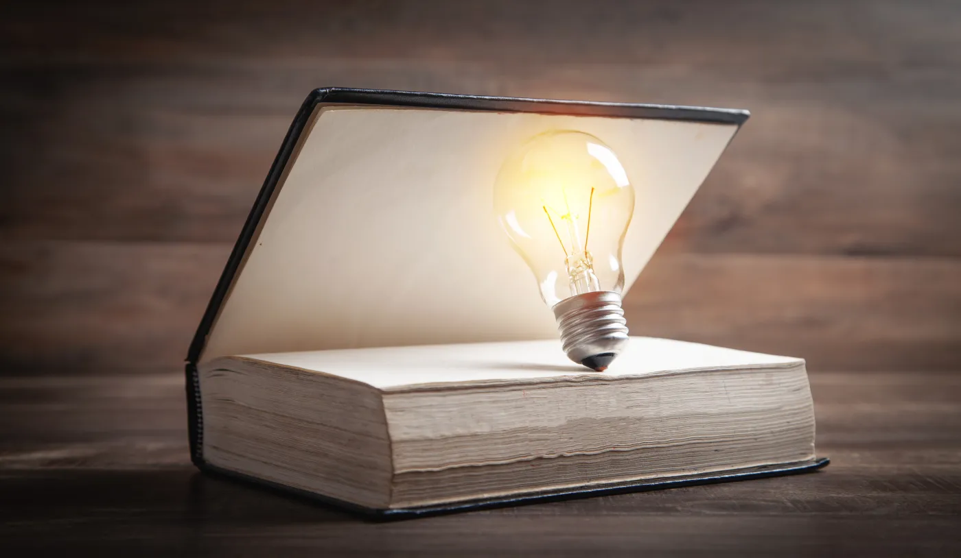 Light,Bulb,And,Book.,Knowledge,And,Wisdom