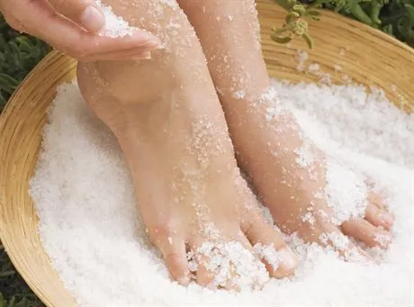 Womans Feet in Salt Scrub Treatment --- Image by  Joerg SteffenszefaCorbis