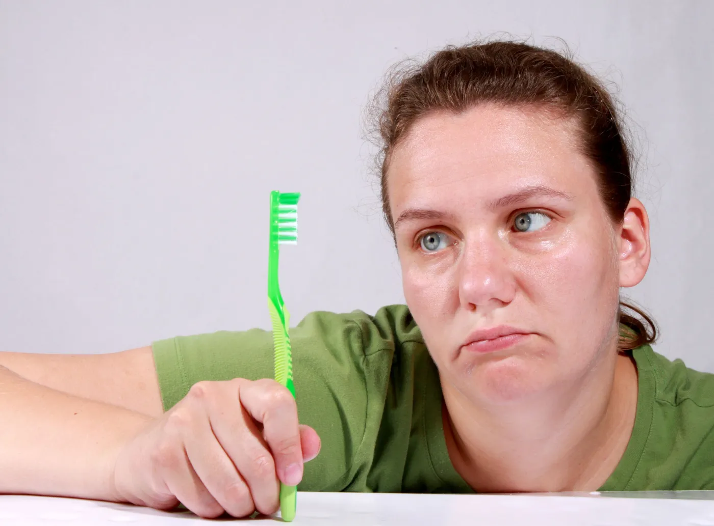 Kobieta trzyma szczoteczkę do zębów