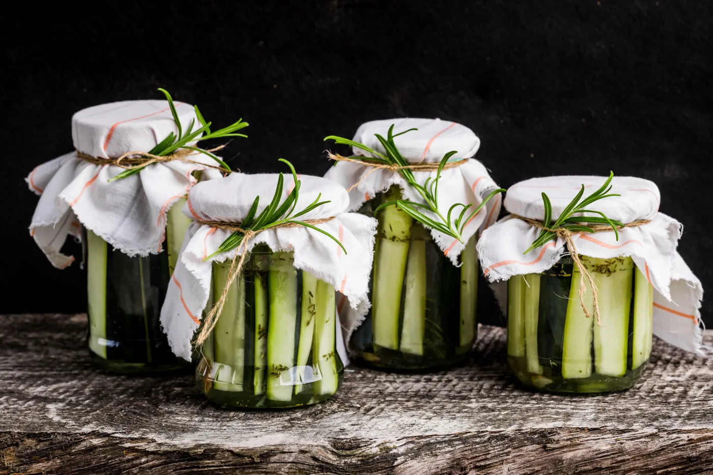 Marinated,Zucchini,With,Rosemary,In,Jars,On,Wooden,Table