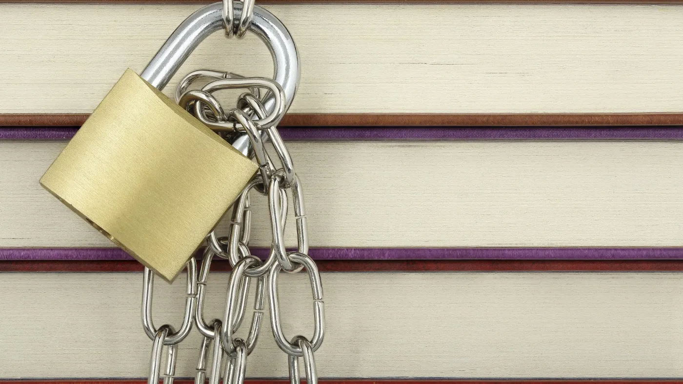 Padlock,With,Chain,Against,Books,Closeup