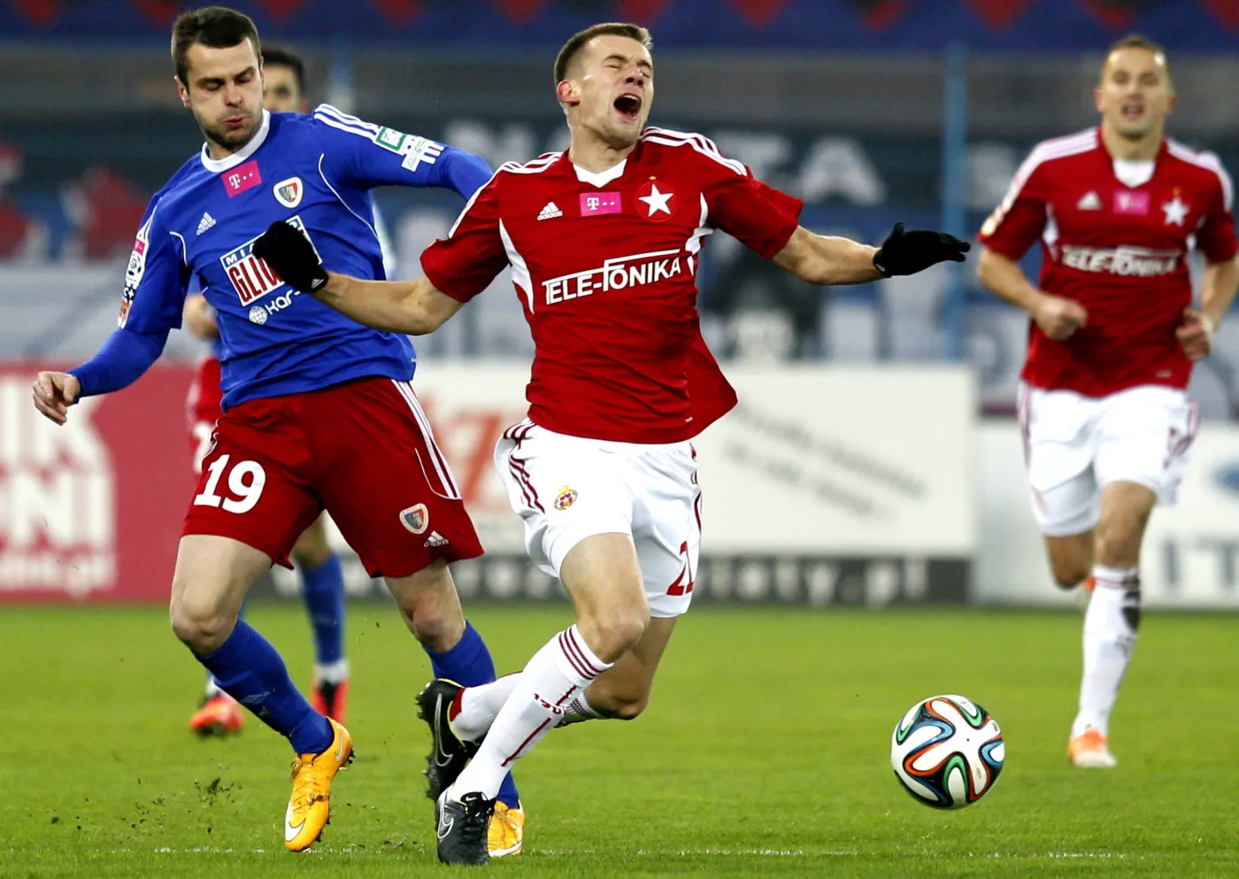 Po interwencji Piotra Brożka (L) z miejscowego Piasta na murawę pada Łukasz Burliga (P) z Wisły Kraków w meczu T-Mobile Ekstraklasy