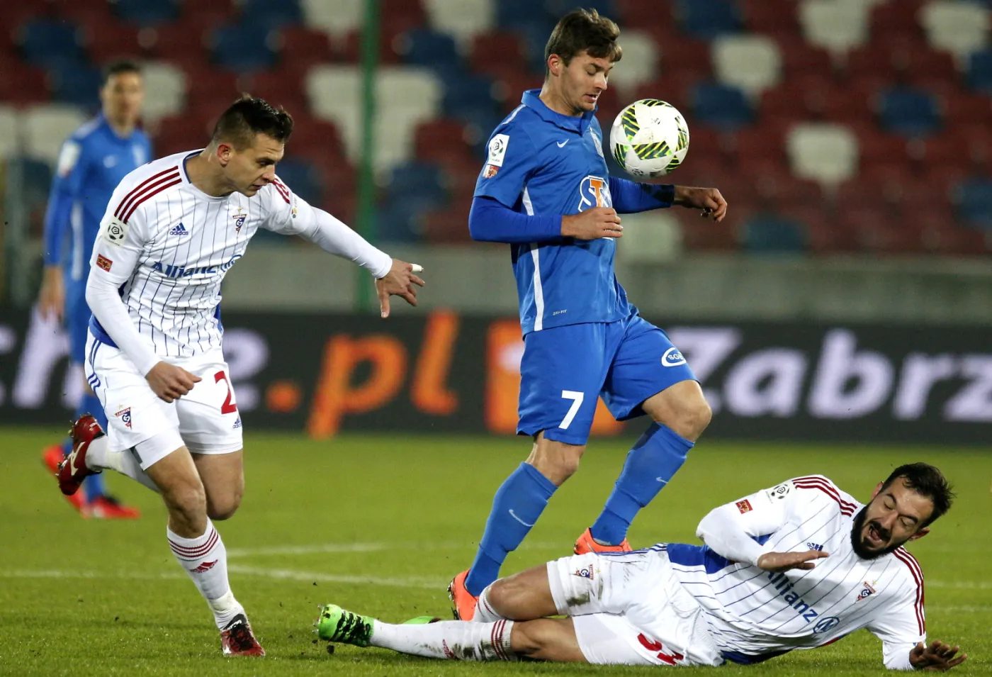 Zawodnicy Górnika Zabrze Paweł Widanow (P) i Bartosz Kopacz (L) walczą o piłkę z Karolem Linetty'm (C) z Lecha Poznań podczas meczu polskiej Ekstraklasy