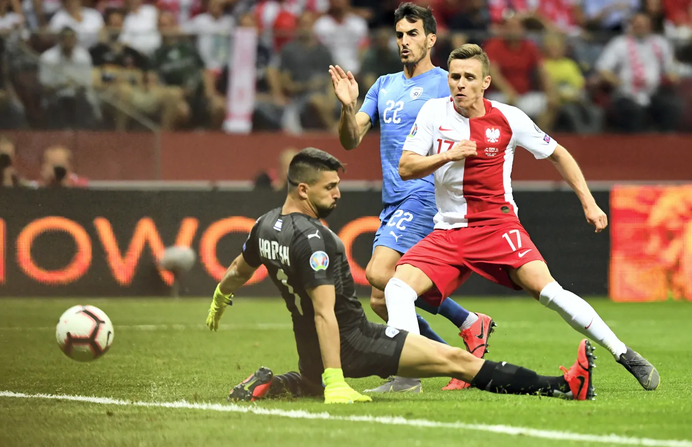 Damian Kądzior (P) oraz bramkarz Ariel Harush (L) i Hatem Elhamed (C)