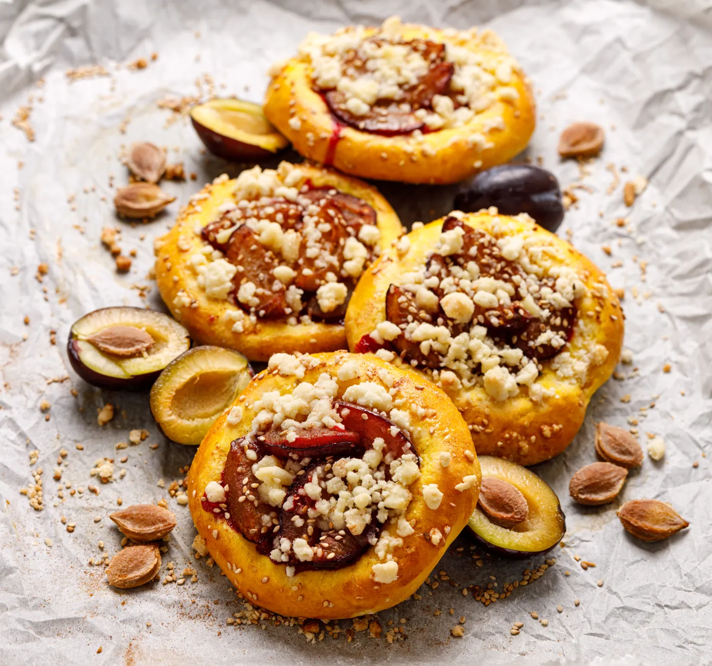 Yeast,Buns,With,Plums,,Pumpkin,And,Crumble,On,Baking,Paper