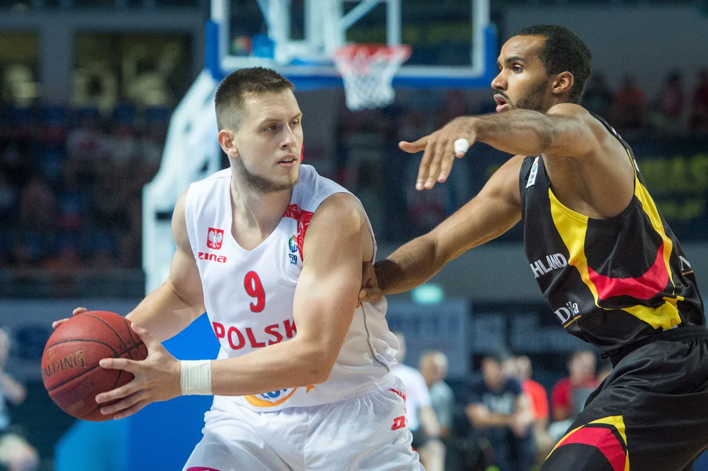 Polak Mateusz Ponitka (L) blokowany przez Niemca Akeema Vargasa (P) podczas meczu eliminacyjnego mistrzostw Europy koszykarzy w Toruniu