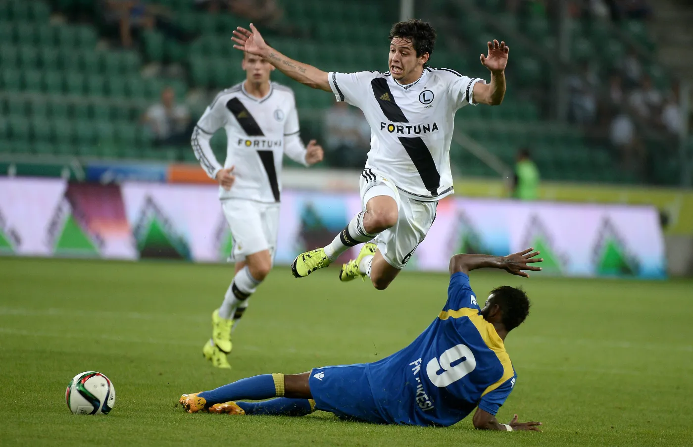 Zawodnik Legii Warszawa Guilherme (wyżej) walczy o piłkę z Erickiem Bonfim Floresem z albańskiego FK Kukesi podczas rewanżowego meczu 3. rundy eliminacyjnej Ligi Europejskiej