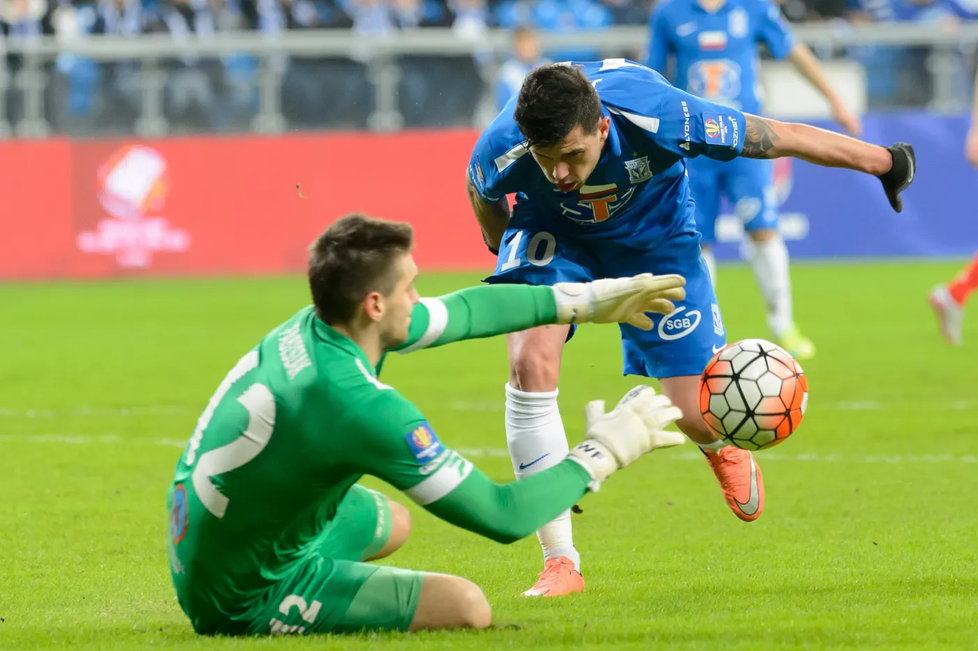 Piłkarz Lecha Poznań Darko Jevtic (P) w ataku na bramkę Wojciecha Fabisiaka (L) z Zagłębia Sosnowiec podczas pierwszego meczu półfinałowego Pucharu Polski