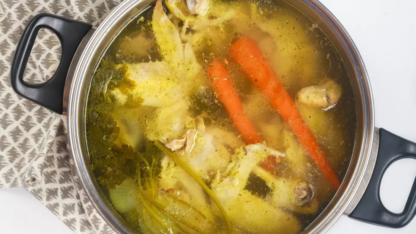 In,A,Metal,Pot,,Chicken,Broth,Is,Simmered,With,Pieces