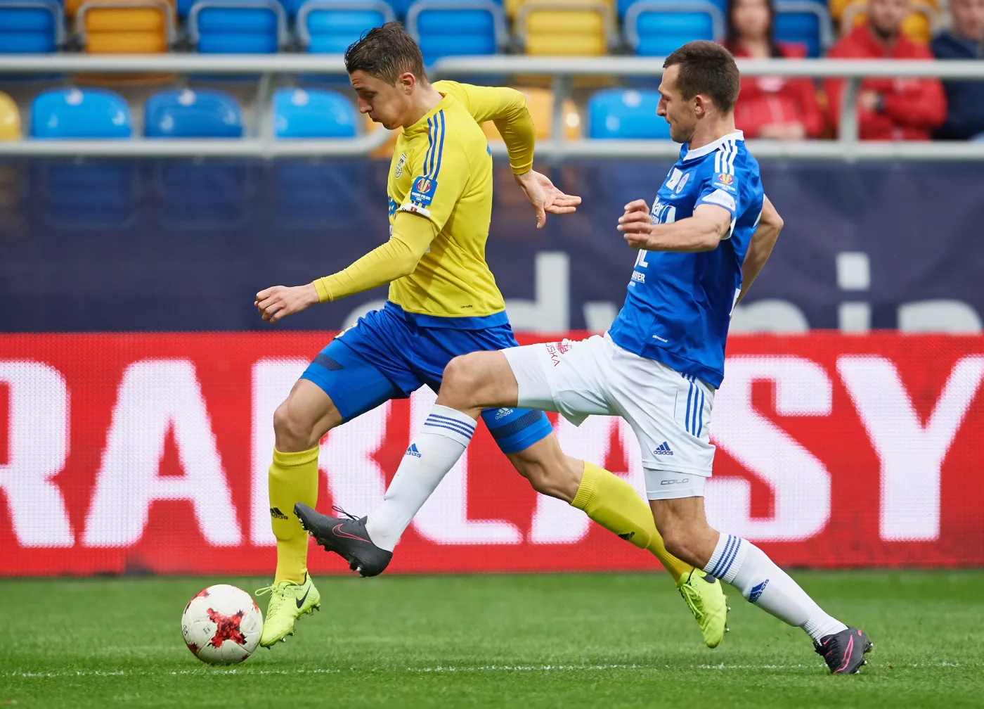 Zawodnik Arki Gdynia Damian Zbozień (L) i Mateusz Radecki (P) z Wigier Suwałki