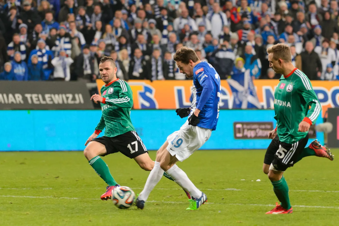 Zawodnik Lecha Poznań Kasper Hamalainen (C) mimo asysty Legionistów Tomasza Brzyskiego (L) i Jakuba Rzeźniczaka (P) strzela bramkę Legii Warszawa podczas meczu 25. kolejki T-Mobile Ekstraklasy