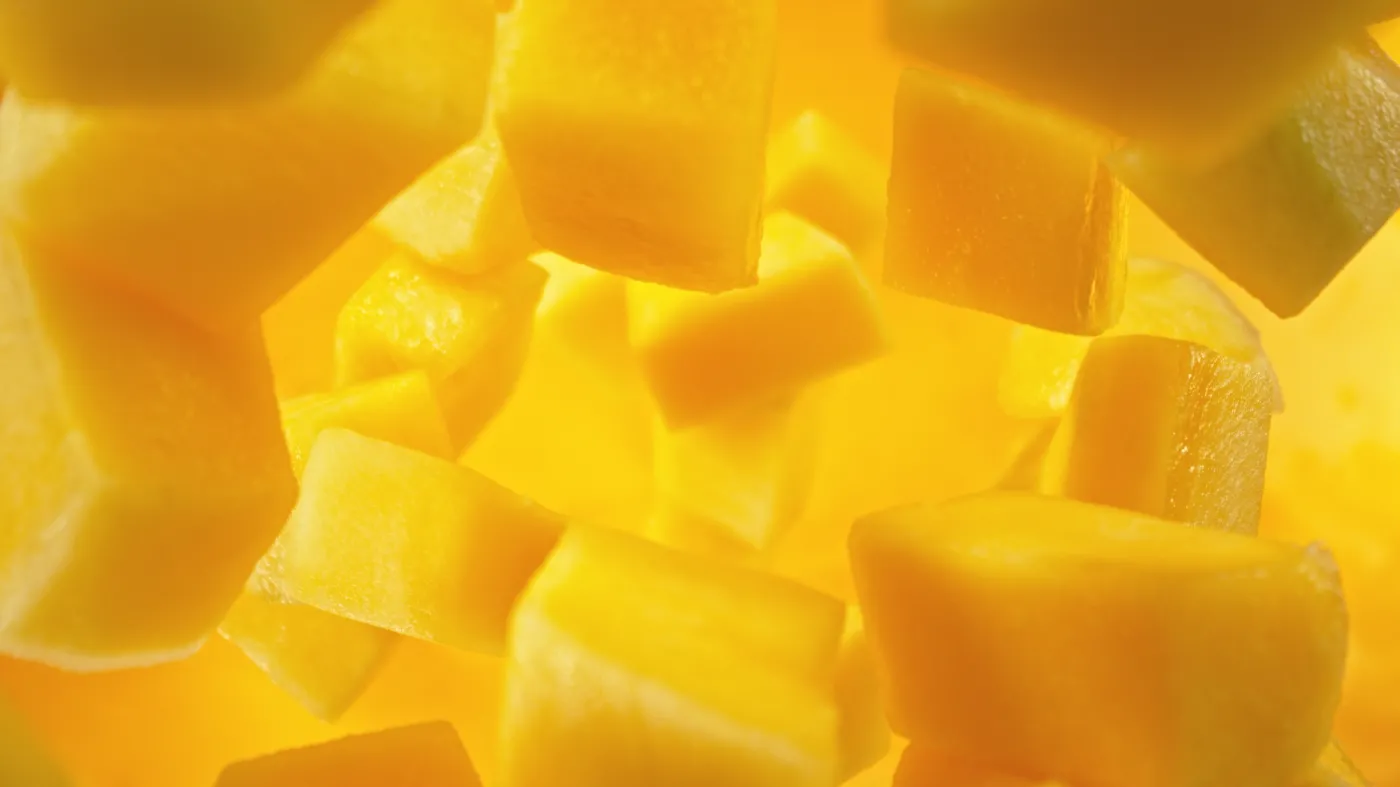 Fresh,Mango,Pieces,Falling,Into,Water,,Top,Down,View