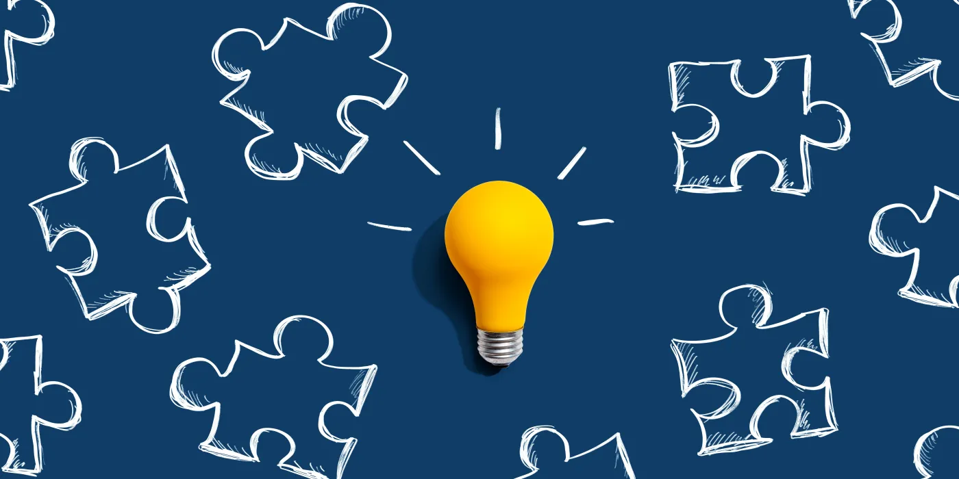 Jigsaw,Puzzle,With,A,Yellow,Light,Bulb,-,Flat,Lay