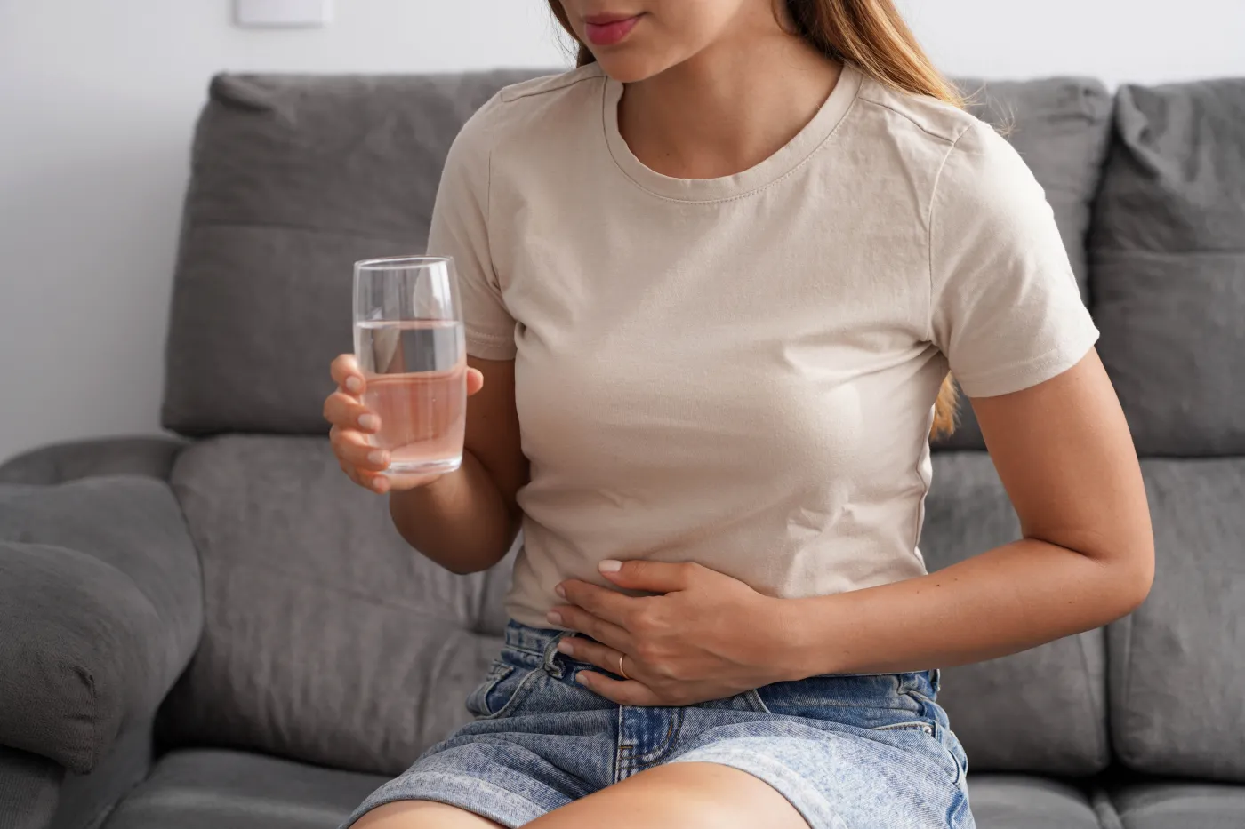 Costiveness.,Unreconizable,Young,Woman,Suffering,From,Abdominal,Pain,Holds,A