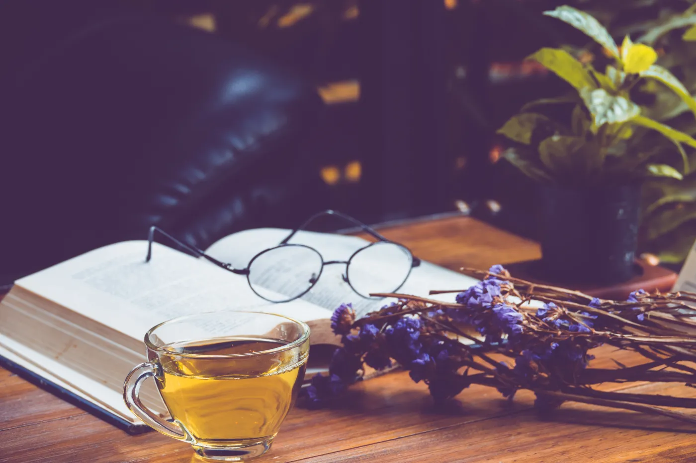 Hot,Tea,In,A,Cup,With,Old,Book,And,Flower