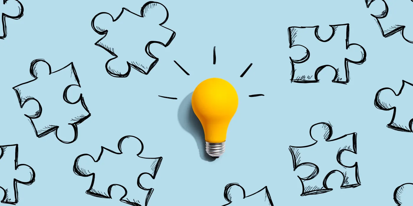 Jigsaw,Puzzle,With,A,Yellow,Light,Bulb,-,Flat,Lay