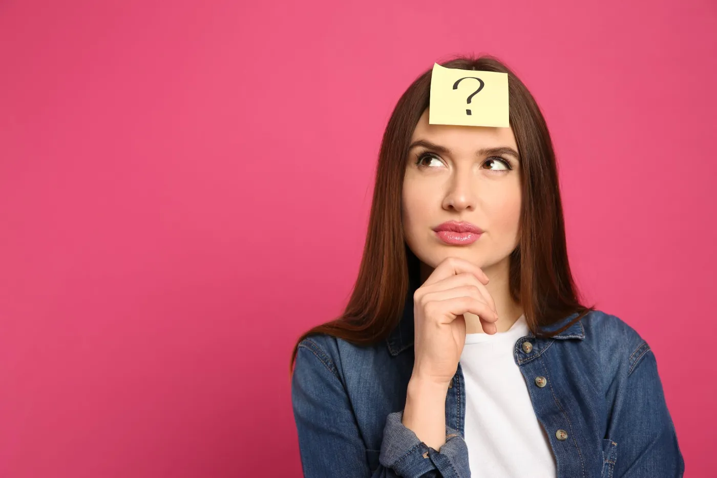 Pensive,Woman,With,Question,Mark,Sticker,On,Forehead,Against,Pink