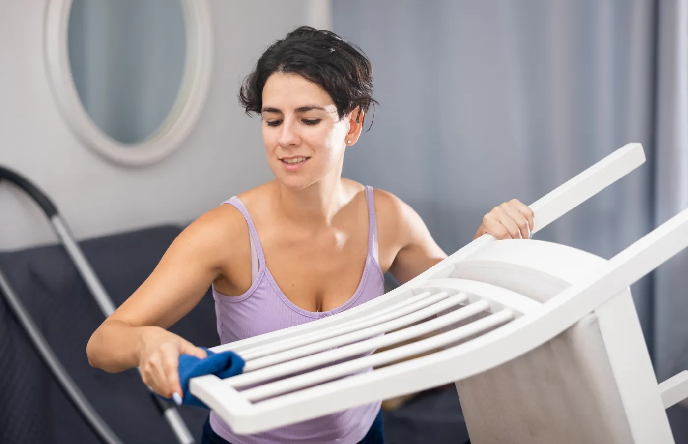 Latino,Woman,Doing,Cleaning,In,The,Room,-,Dusting,The