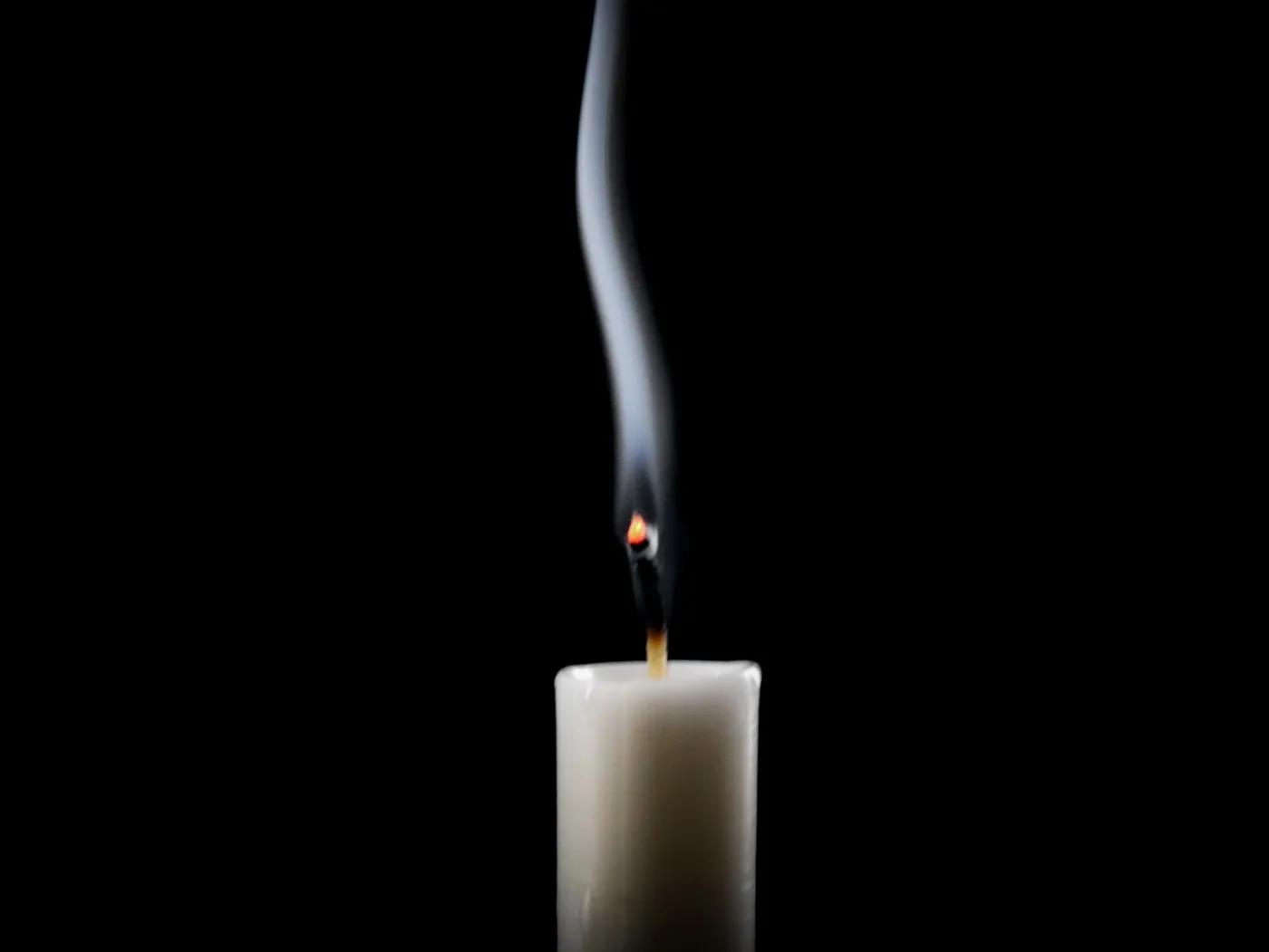 Candle,Extinguished,,Smoke,Rising,Against,Black,Background.