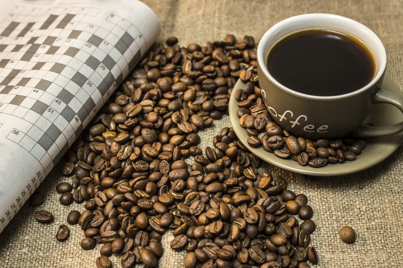 A,Cup,Of,Coffee,With,Scattered,Coffee,Beans,Are,Stands