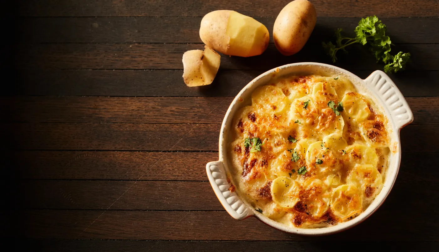 The,Top,View,Of,Appetizing,Gratin,Baked,Potato,With,Cheese