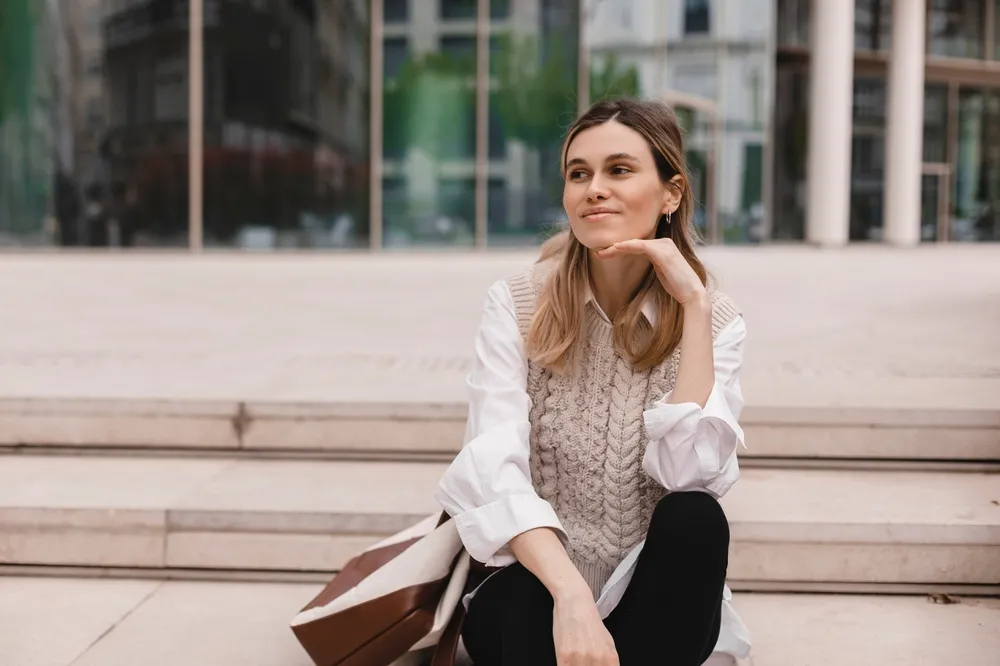 Attractive,Blonde,Woman,Sitting,On,Stairs,Near,Office,Building,And
