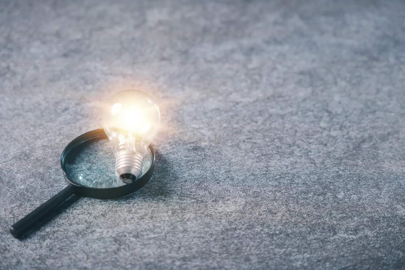 College,Career,Ideas,Shine,Through,Glowing,Lightbulb,Placed,Over,Magnifying