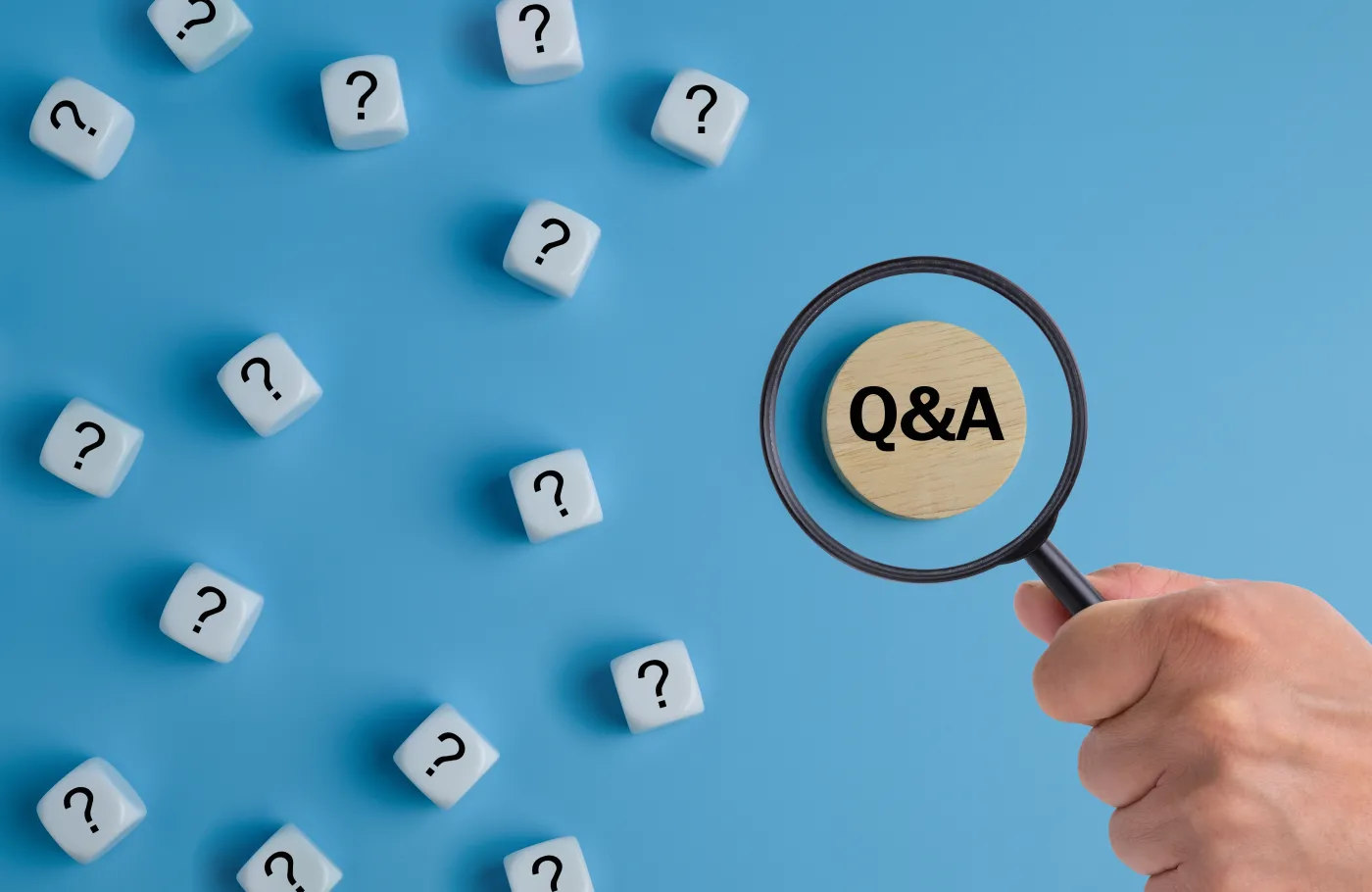 Hand,Holding,Magnifying,Glass,Focusing,On,Q,And,A,Text