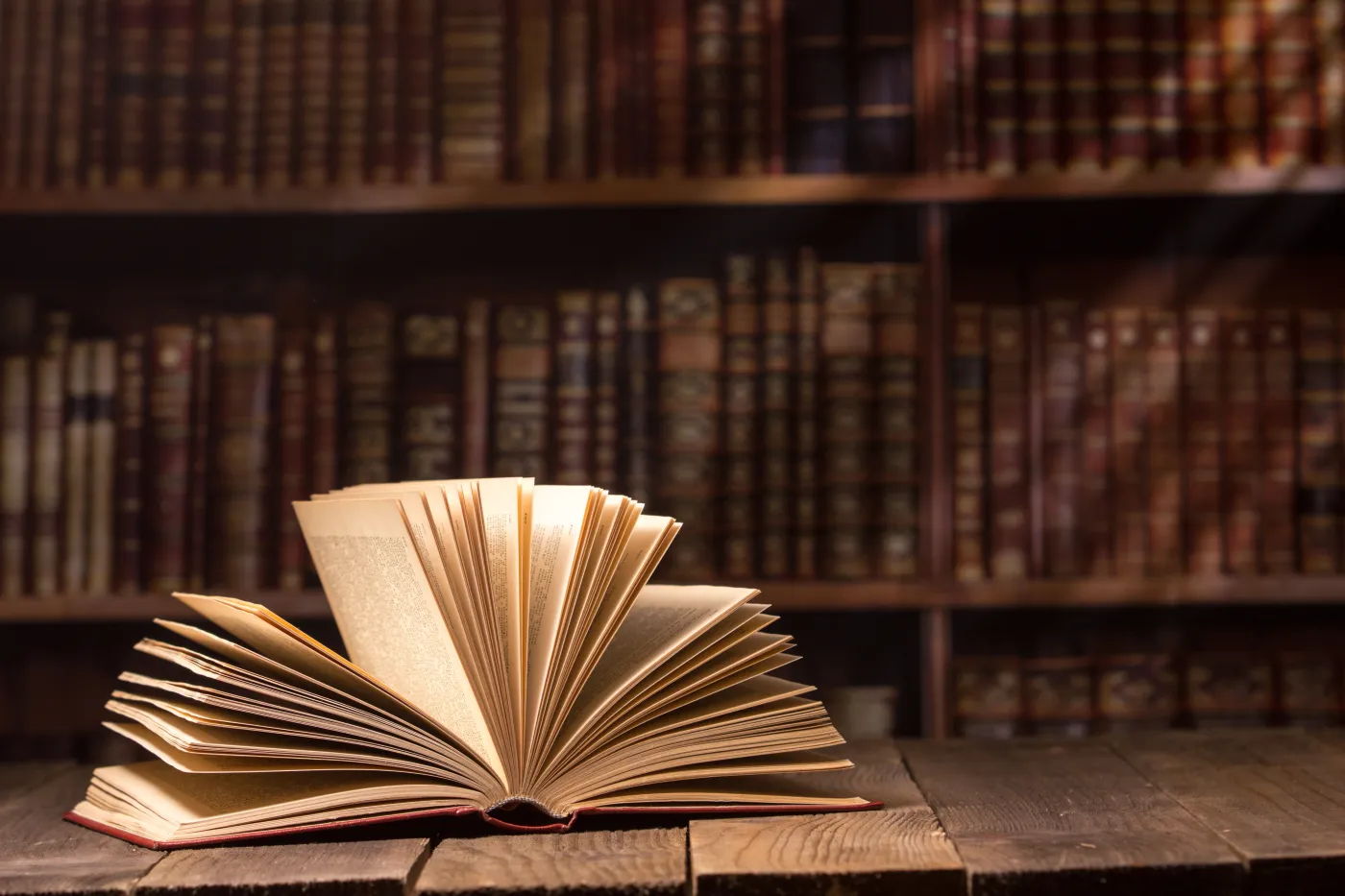 Vintage,Old,Hardback,Books,,Diary,,Fanned,Pages,On,Wooden,Desk