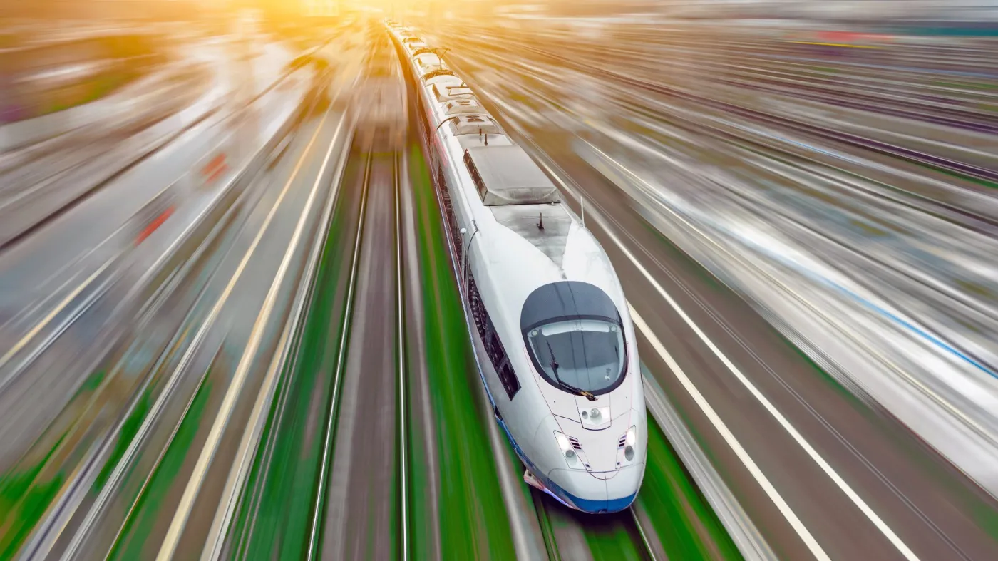 High-speed,Passenger,Train,Travels,At,High,Speed,Railroad,Green,Grass.