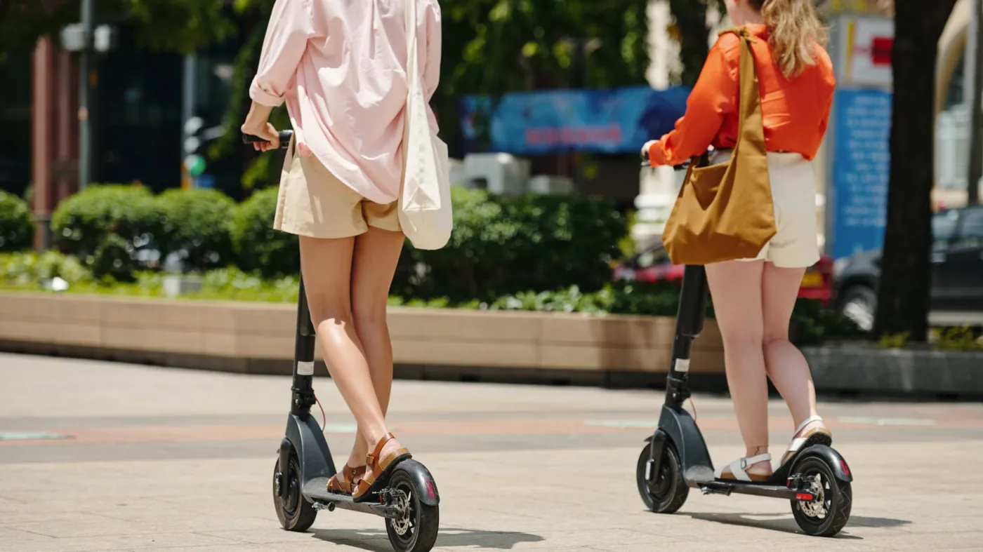 Riding,Electric,Scooters,Through,Urban,Landscape