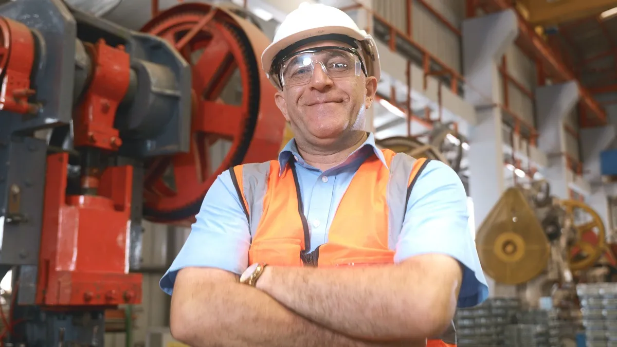 bhp w przemyśle bezpieczeństwo niebezpieczeństwo higiena pracy kask hełm okulary kamizelka pracownik robotnik senior starszy zadowolony