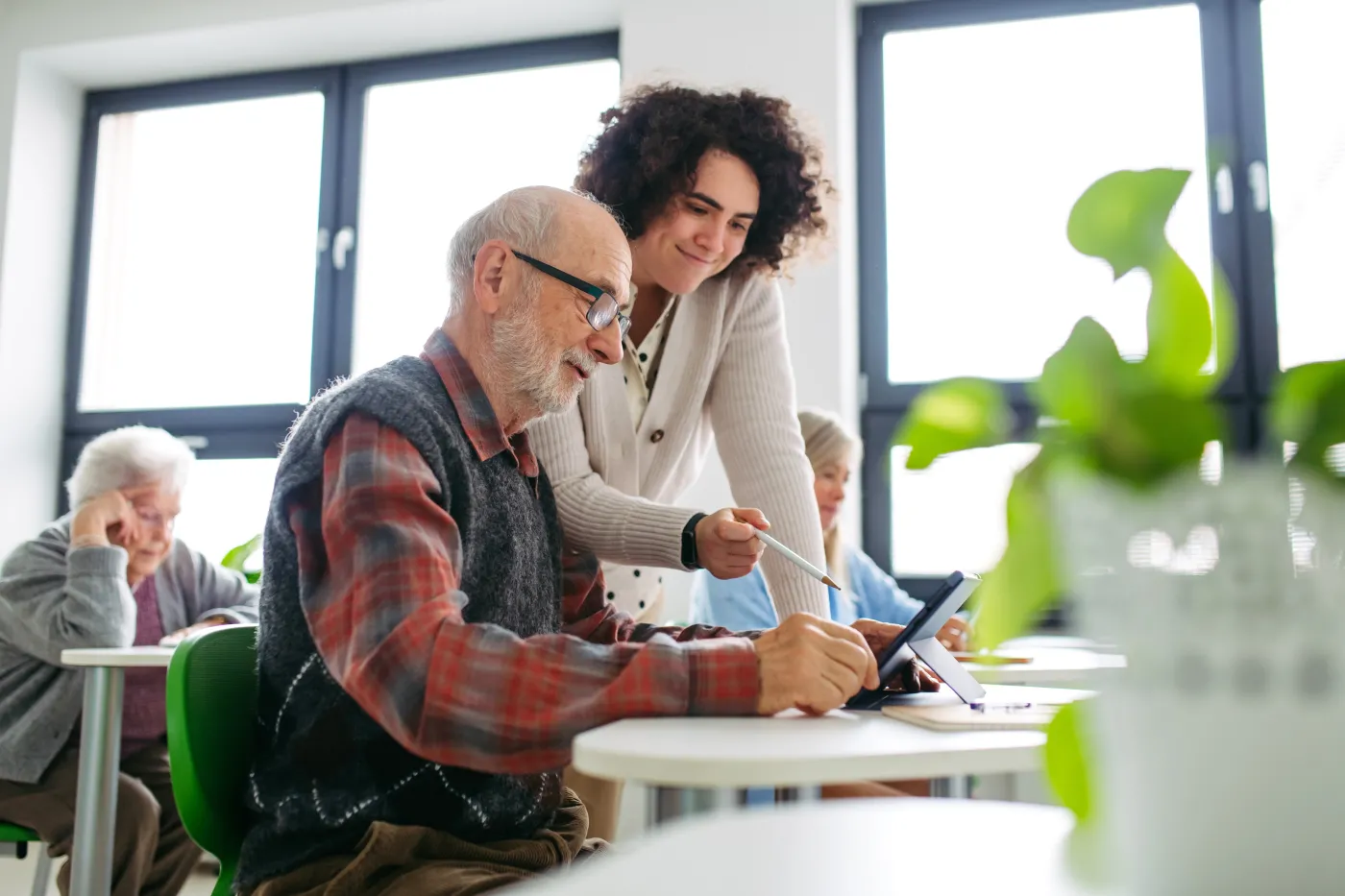 Senior,Man,Learning,Digital,Skills,With,Tutor,Support,In,Community