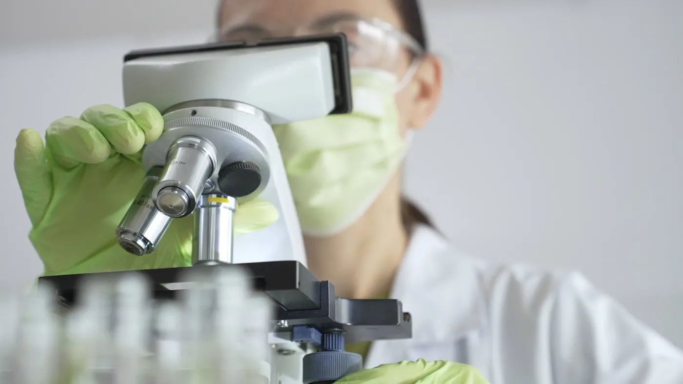 Close,Up,Of,Scientific,Precision,Involving,Green,Gloved,Hands,Adjusting